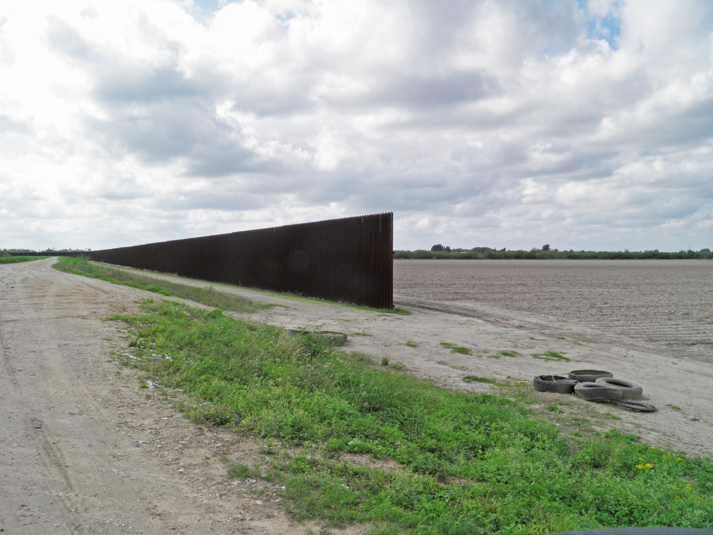 The eastern start of the U.S. border fence is seen in this photo taken at the Loop family farm in Brownsville