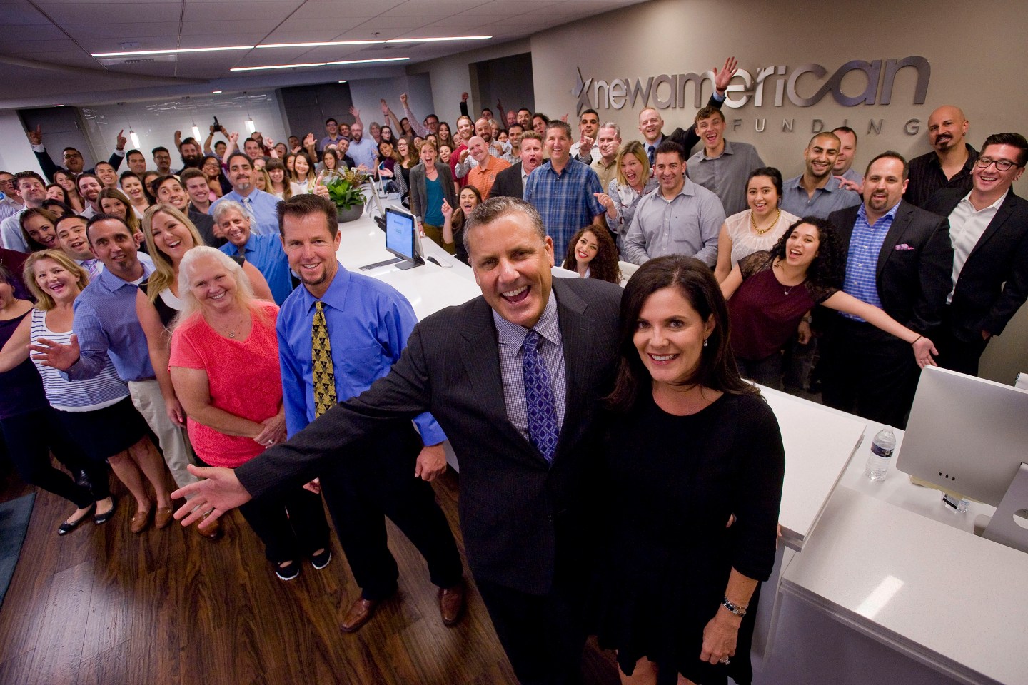 Rick and Patty Arvielo, center foreground, with employees of their company New American Funding in Tustin. ///ADDITIONAL INFO: twp.newamericanfunding.1203 - 10/21/15 - Photo by PAUL RODRIGUEZ, STAFF PHOTOGRAPHER - Rick and Patty Arvielo with employees of their company New American Funding in Tustin.