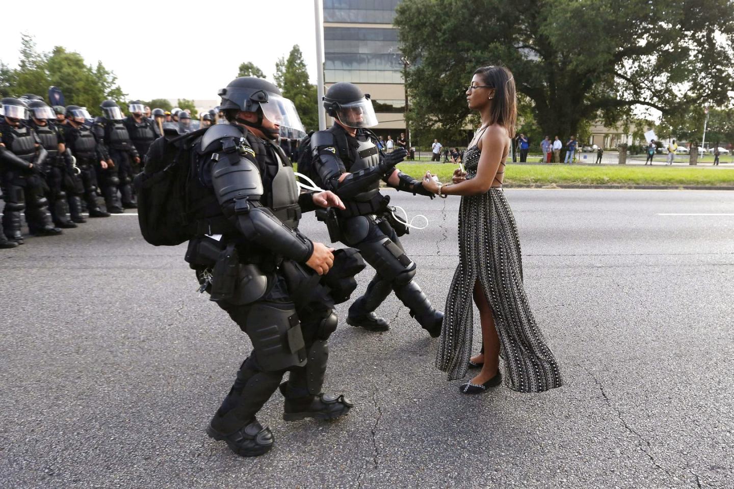 FILE PHOTO -- Lone activist Ieshia Evans stands her ground while offering her hands for arrest as she is charged by riot police during a protest against police brutality outside the Baton Rouge Police Department in Louisiana