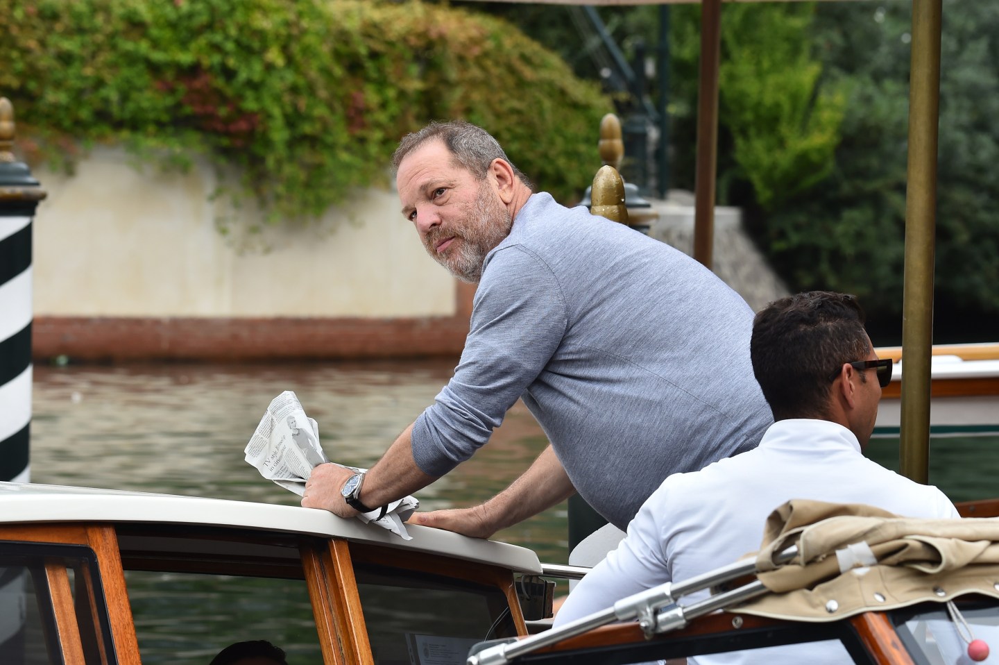 Harvey Weinstein boards a taxi boat.