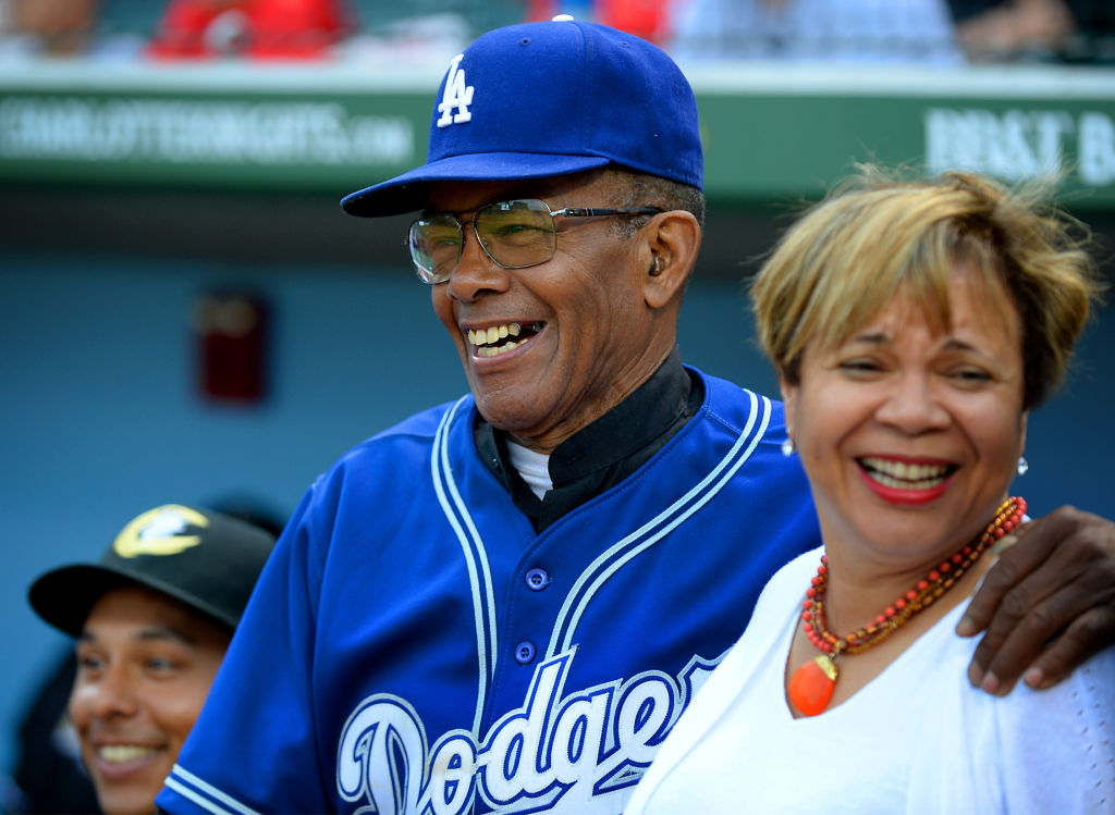 Vi Lyles embraced by Negro League Baseball player Bill Cathcart at stadium
