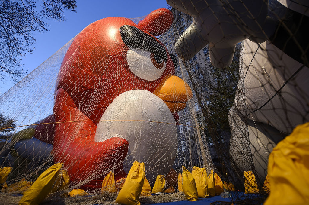 The red angry birds balloon for the Macy's Thanksgiving Day Parade is inflated, contained by net