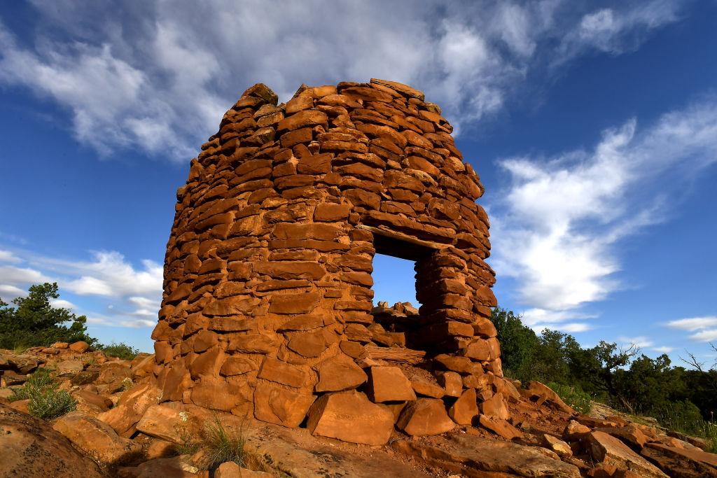 The orange stones of Pueblo ruins in Bears Ears National Monument, Utah, appear against a blue sky 