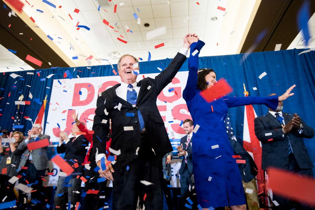 Alabama Democrat Senator-elect Doug Jones celebrates his victory, holding hands with wife Louise at victory party as confetti rains 