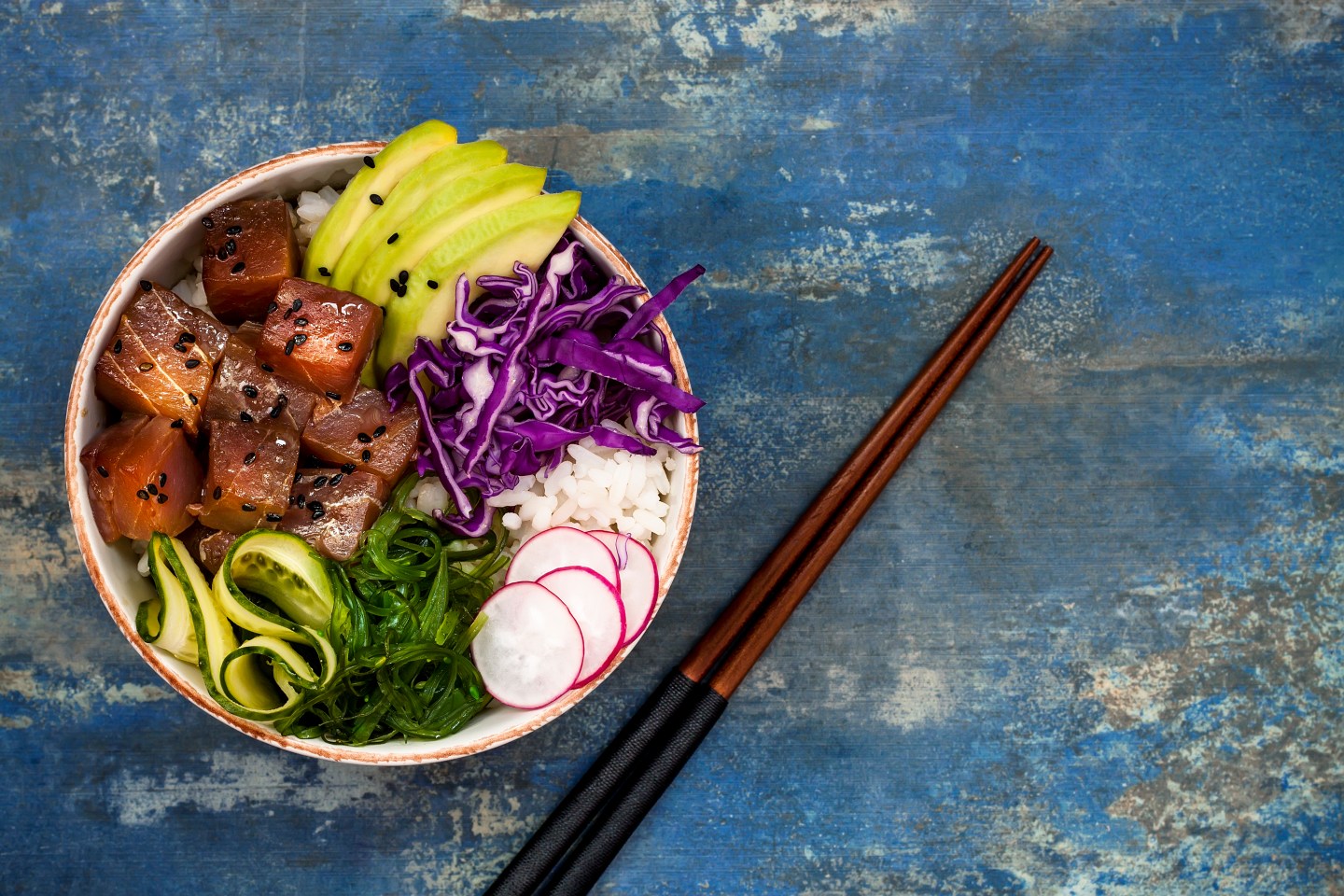 Hawaiian tuna poke bowl with seaweed, avocado, red cabbage slaw