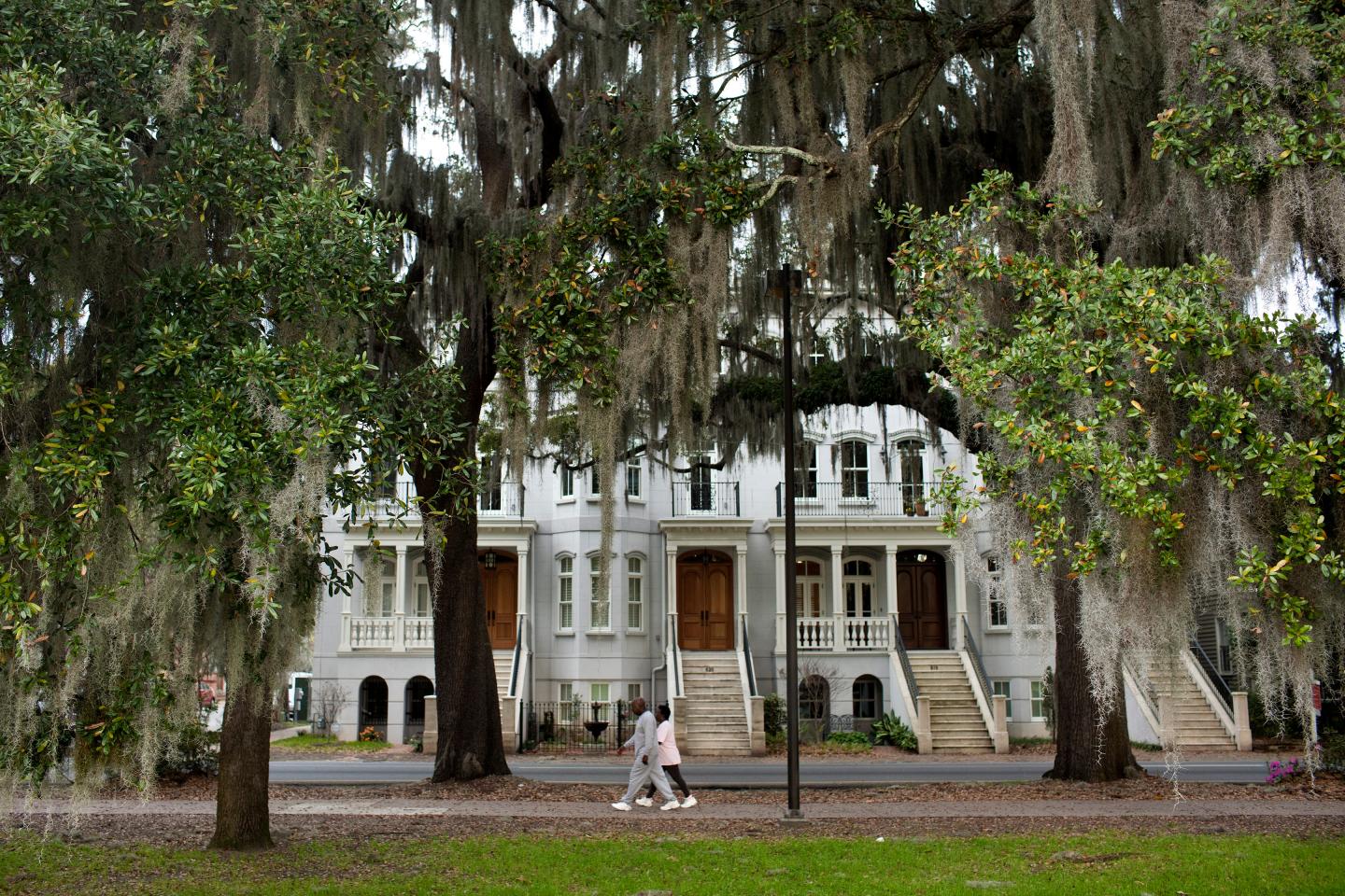 A couple walks along Forsyth Park March