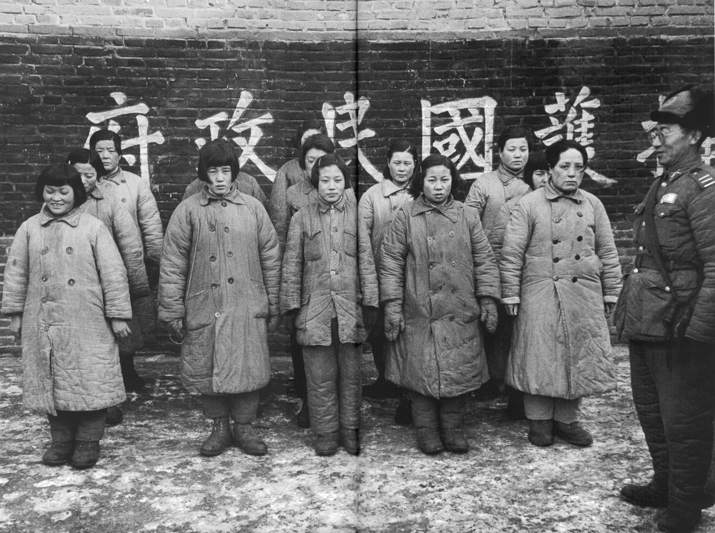 A Nationalist officer guarding women prisoners said to be "comfort girls" used by the Communists.(This is a photograph of an image reproduced in book "Assignment Shanghai").