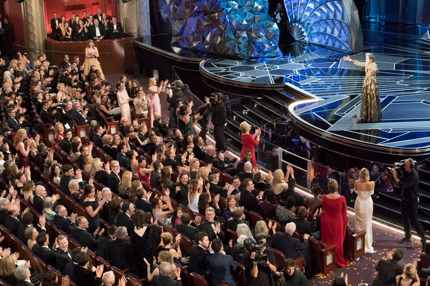 Female Oscar nominees stand in the audience as Frances McDormand delivers her Oscars speech.
