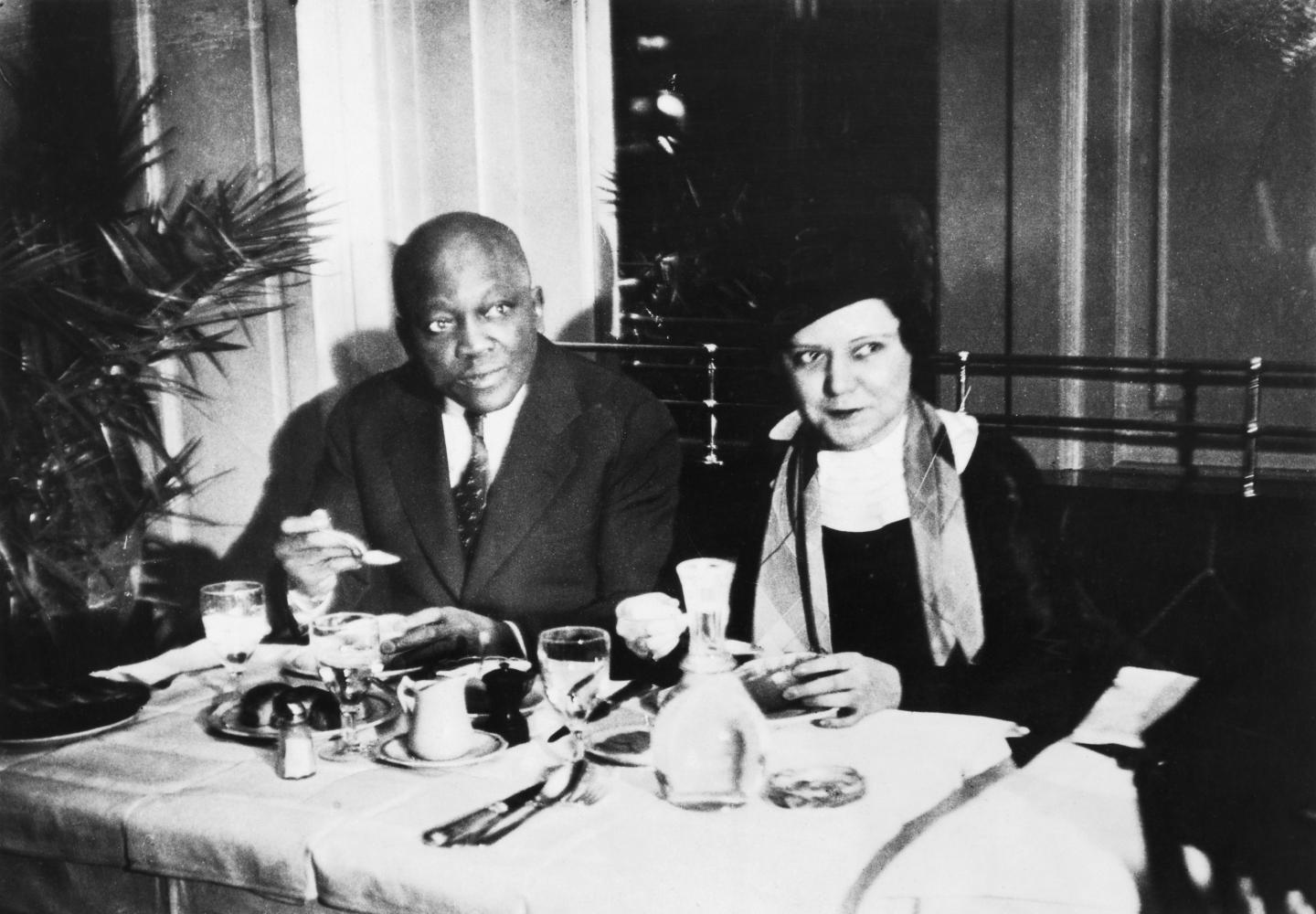 Jack Johnson and his wife Irene sit at a table which is set.