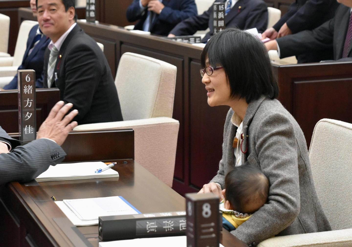 Kumamoto City assembly member Yuka Ogata holds her baby during a session in Kumamoto
