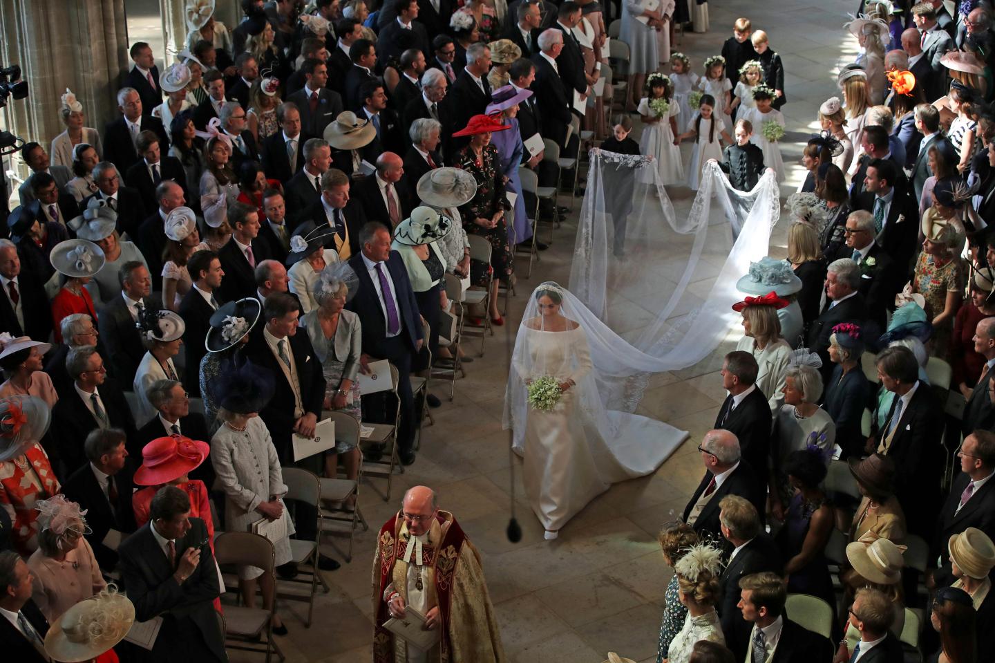Meghan Markle, in Givenchy wedding dress, walks the majority of the aisle by herself. 
