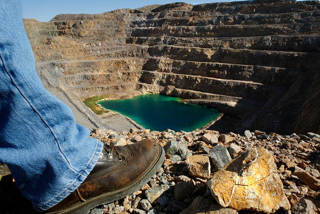 SEPTEMBER 11, 2009. MOUNTAIN PASS, CA. John Espinoza looks down on ground water that has accumulate