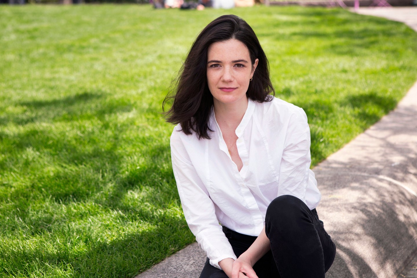 Google employee Claire Stapleton sitting on grass