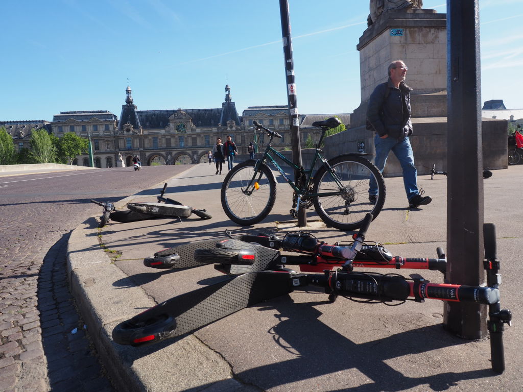 Electric scooters lie on the Pont du Carrousel bridge in Paris, France. Christian Böhmer—picture alliance via Getty Images
