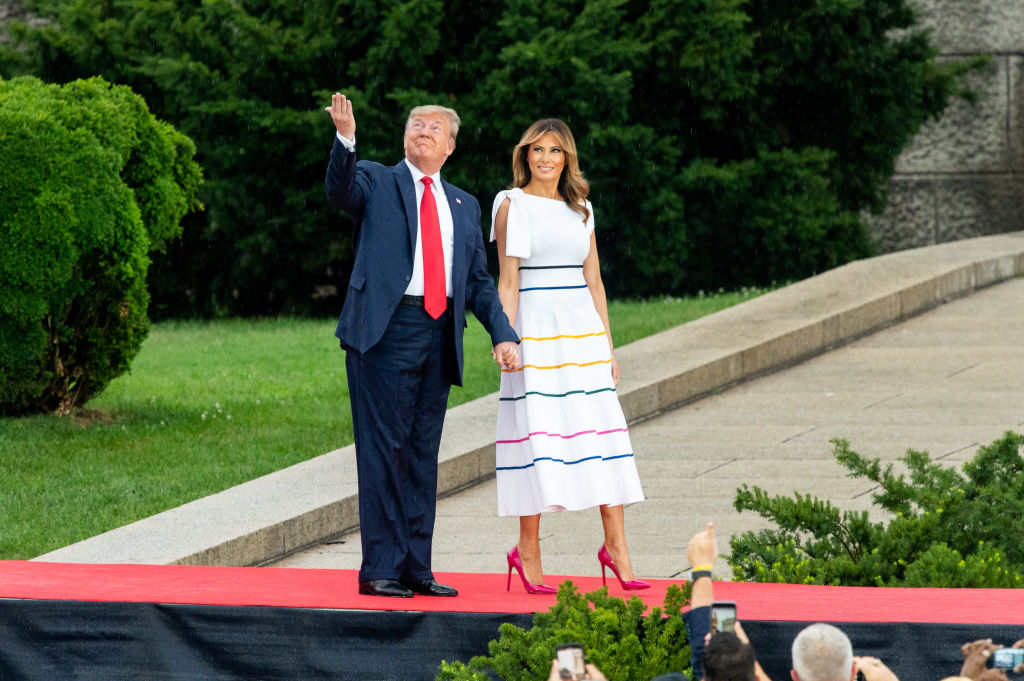 Donald and Melania Trump wave to spectators at July 4 event