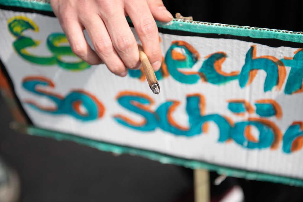 A protestor demanding the legalisation of cannabis smokes a joint in Berlin, Germany.