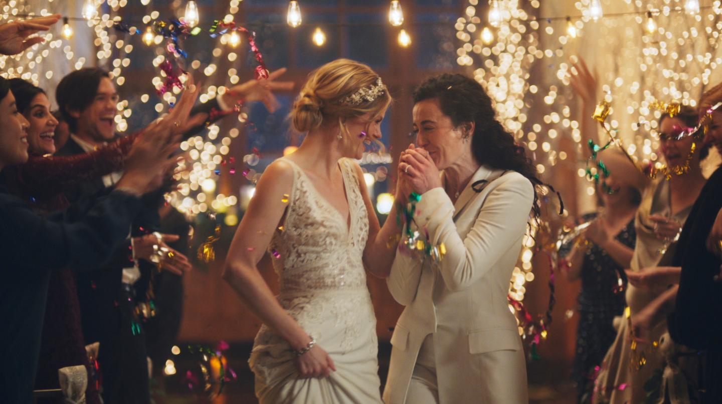This image made from undated video provided by Zola shows a scene of its advertisement. The Hallmark Channel says it will reinstate same-sex marriage commercials that it had pulled from the network. Hallmark Cards CEO Mike Perry said in a statement Sunday, Dec. 15, 2019, that pulling the commercials “was the wrong decision." (Zola via AP)