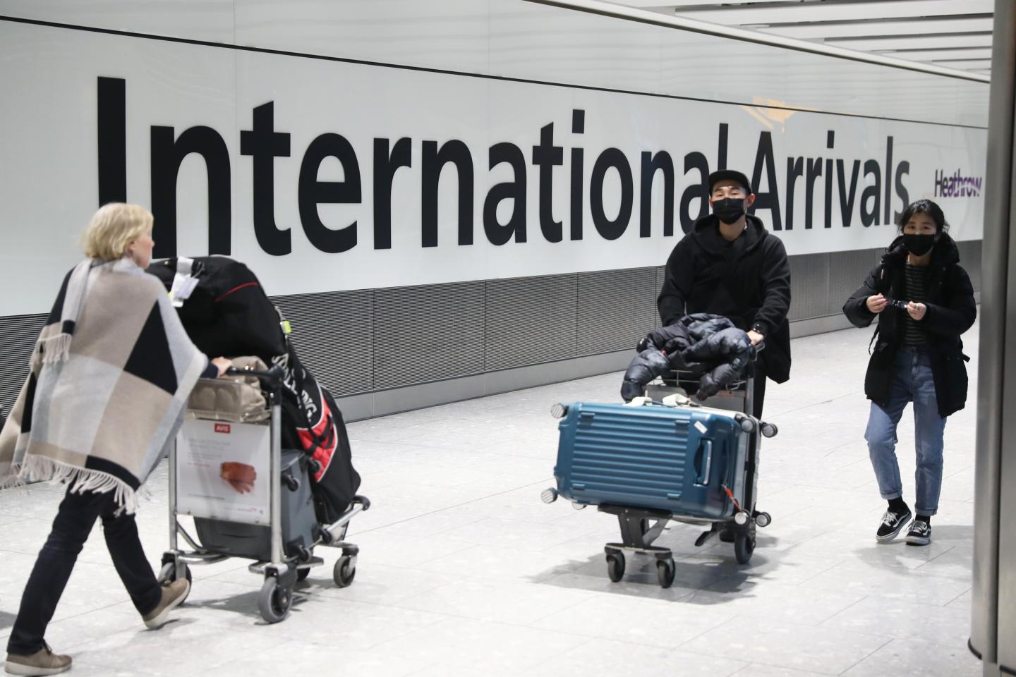 Passengers arrive at Heathrow Airport in London after the last British Airways flight from China touched down in the UK following an announcement that the airline was suspending all flights to and from mainland China with immediate effect amid the escalating coronavirus crisis. (Photo by Steve Parsons/PA Images via Getty Images)