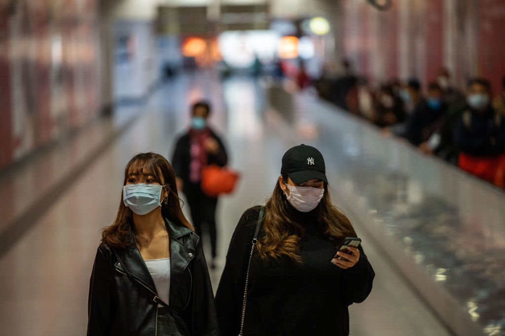 Two female seen wearing surgical masks as a preventative