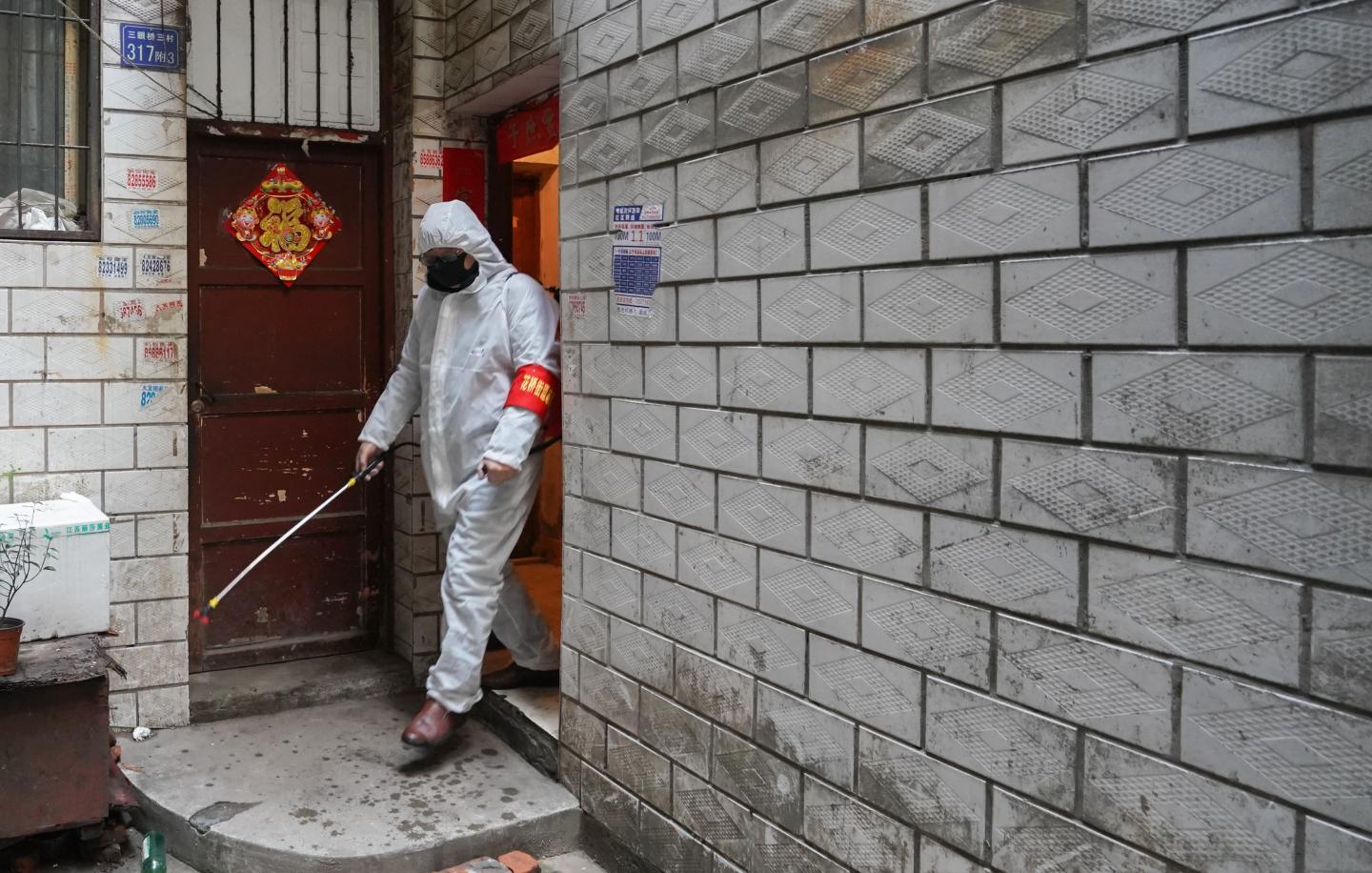 WUHAN, Feb. 9, 2020 -- A volunteer carries out disinfection work in Jiang'an District of Wuhan, central China's Hubei Province, Feb. 9, 2020. Wuhan, the epicenter of the novel coronavirus outbreak, is combing communities to ensure every confirmed or suspected patient is located and attended to. (Photo by Cheng Min/Xinhua via Getty) (Xinhua/Cheng Min via Getty Images)
