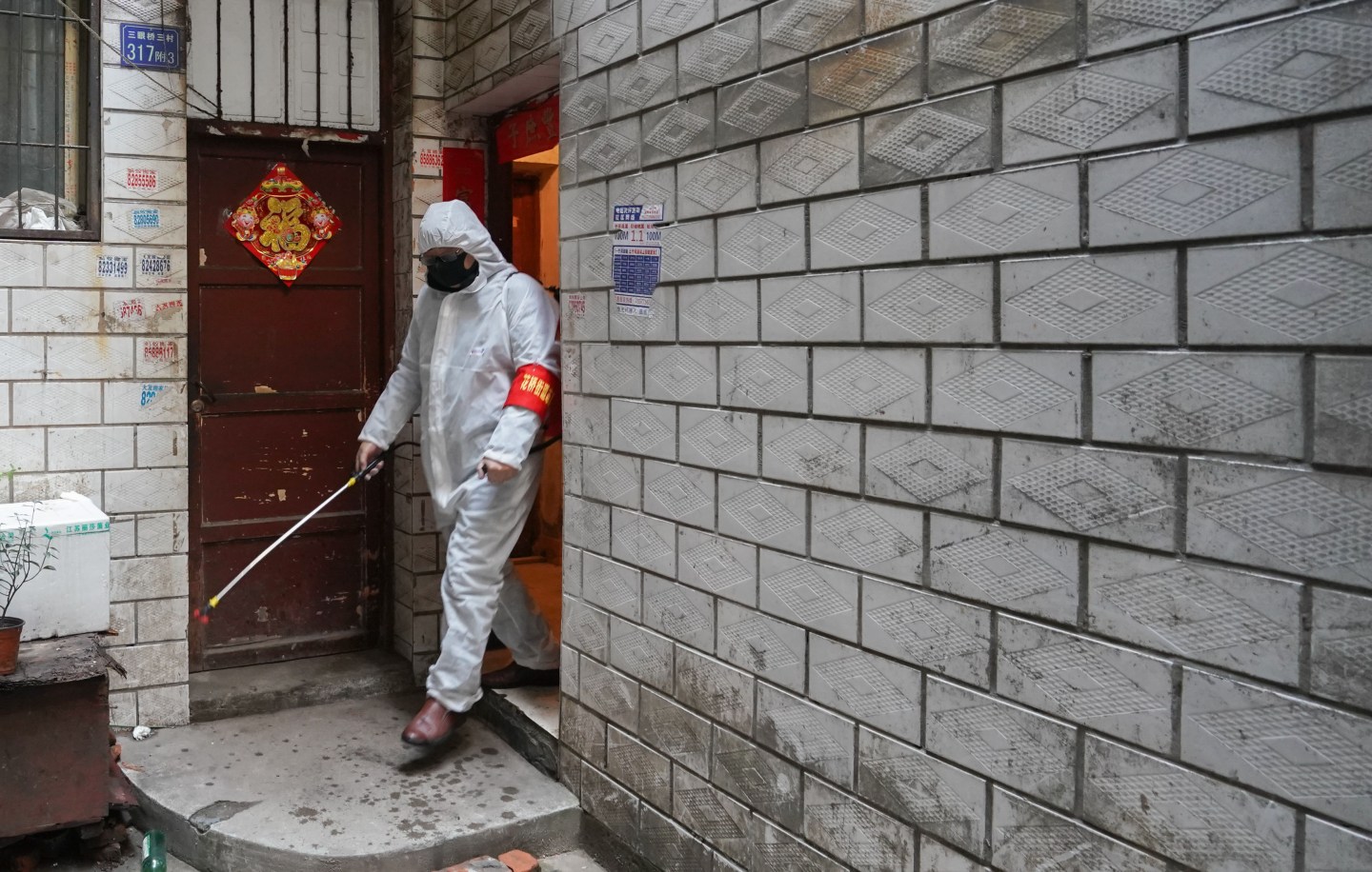 WUHAN, Feb. 9, 2020 -- A volunteer carries out disinfection work in Jiang'an District of Wuhan, central China's Hubei Province, Feb. 9, 2020. Wuhan, the epicenter of the novel coronavirus outbreak, is combing communities to ensure every confirmed or suspected patient is located and attended to. (Photo by Cheng Min/Xinhua via Getty) (Xinhua/Cheng Min via Getty Images)