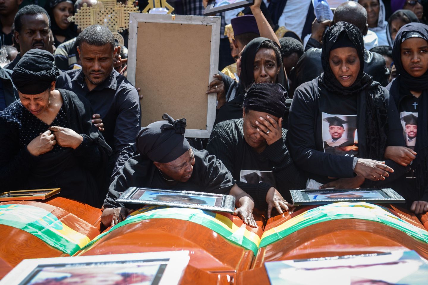 TOPSHOT - Mourners of victims of the crashed accident of Ethiopian Airlines react beside coffins during the mass funeral at Holy Trinity Cathedral in Addis Ababa, Ethiopia, on March 17, 2019. - The crash of Flight ET 302 minutes into its flight to Nairobi on March 10 killed 157 people onboard and caused the worldwide grounding of the <a href="https://fortune.com/company/boeing/" target="_blank">Boeing</a> 737 MAX 8 aircraft model involved in the disaster. (Photo by Samuel HABTAB / AFP) (Photo credit should read SAMUEL HABTAB/AFP via Getty Images)