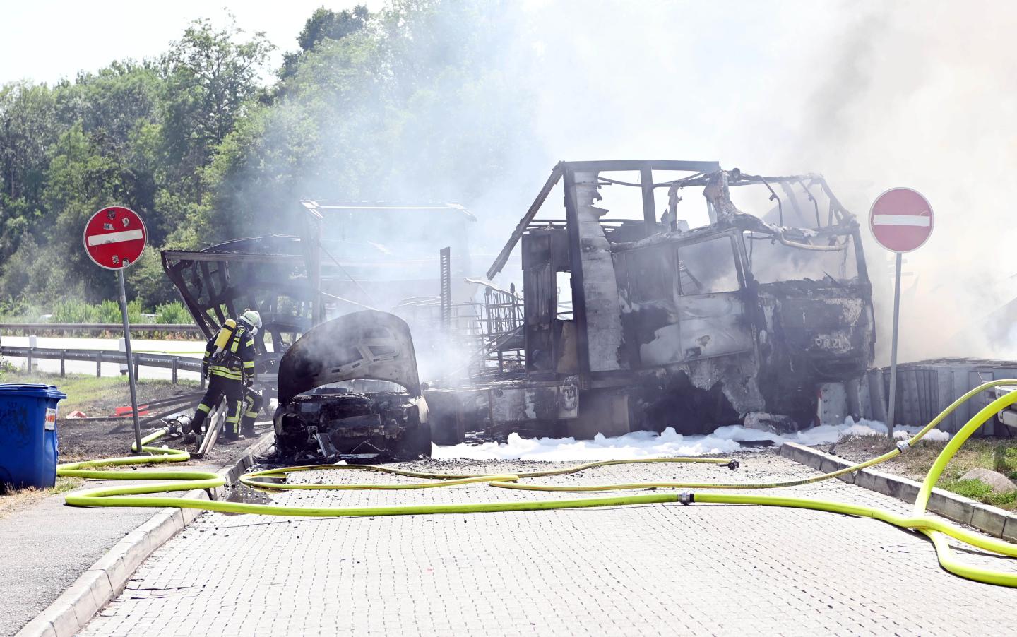 22 July 2019, Baden-Wuerttemberg, Karlsruhe: Firefighters extinguish vehicles on Autobahn 5 near Karlsruhe. After a rear-end collision between a truck and a car on the motorway, a fire broke out. According to a police spokesman, details of the cause and possible victims were not known at first. According to eyewitnesses, the development of smoke could be seen many kilometres away. Photo: Uli Deck/dpa (Photo by Uli Deck/picture alliance via Getty Images)