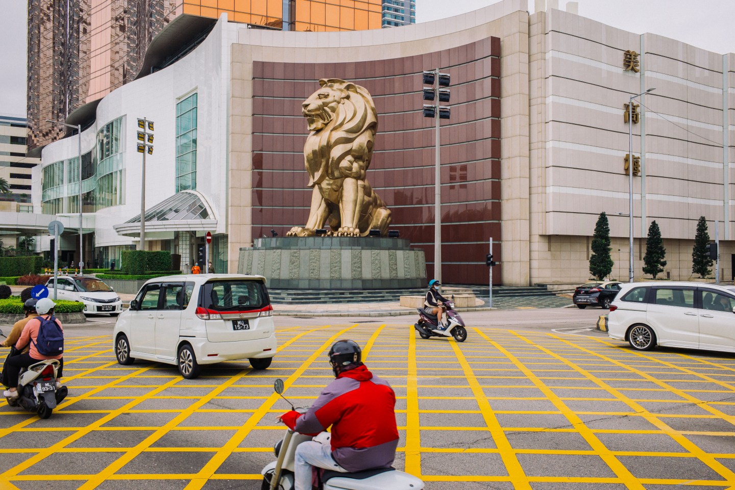 Vehicles moves past a lion statue outside the MGM Cotai casino resort, operated by MGM China Holdings Ltd., in Macau, China, on Tuesday, March 3, 2020. Casinos in Macau, the Chinese territory that's the worlds biggest gambling hub, reported a record drop in gaming revenue, as they grappled with the cost of closing down their businesses for 15 days to help contain the deadly coronavirus outbreak. Photographer: Billy H.C. Kwok/Bloomberg via Getty Images