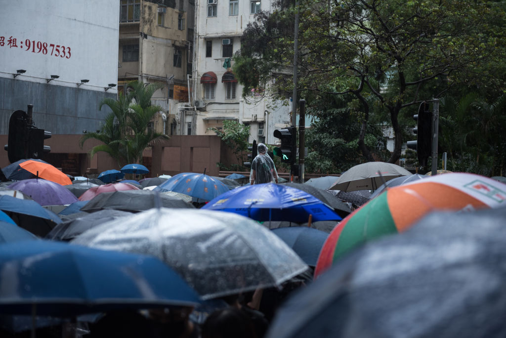 A protester surveys the crowd as demonstrators march through