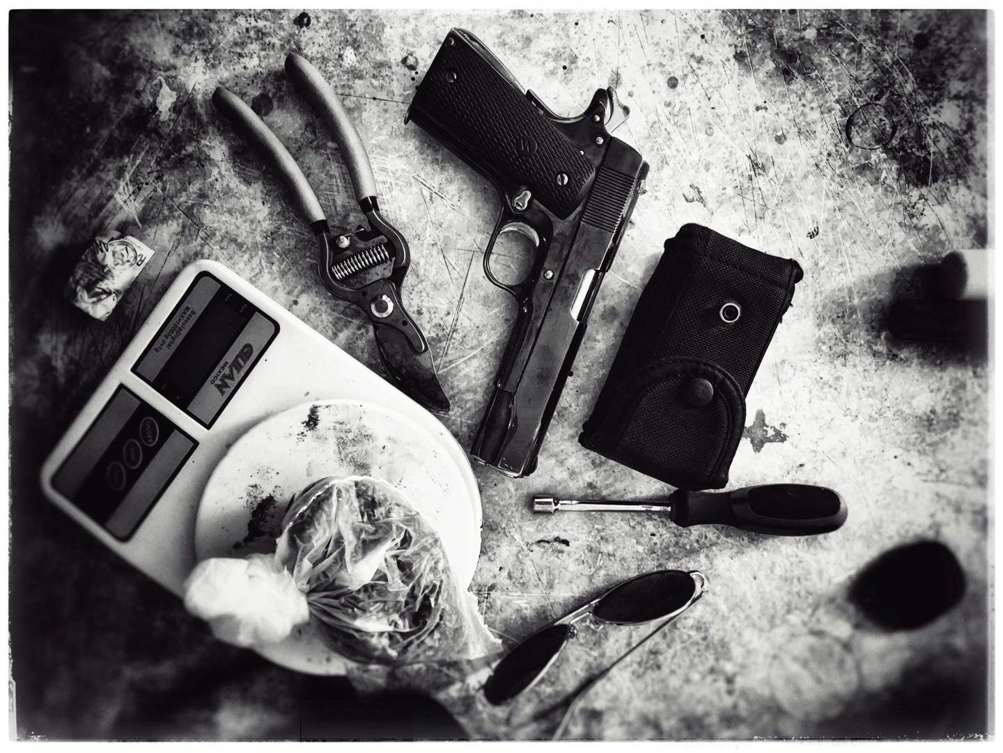 drugs, gun, wire cutter, scale on table