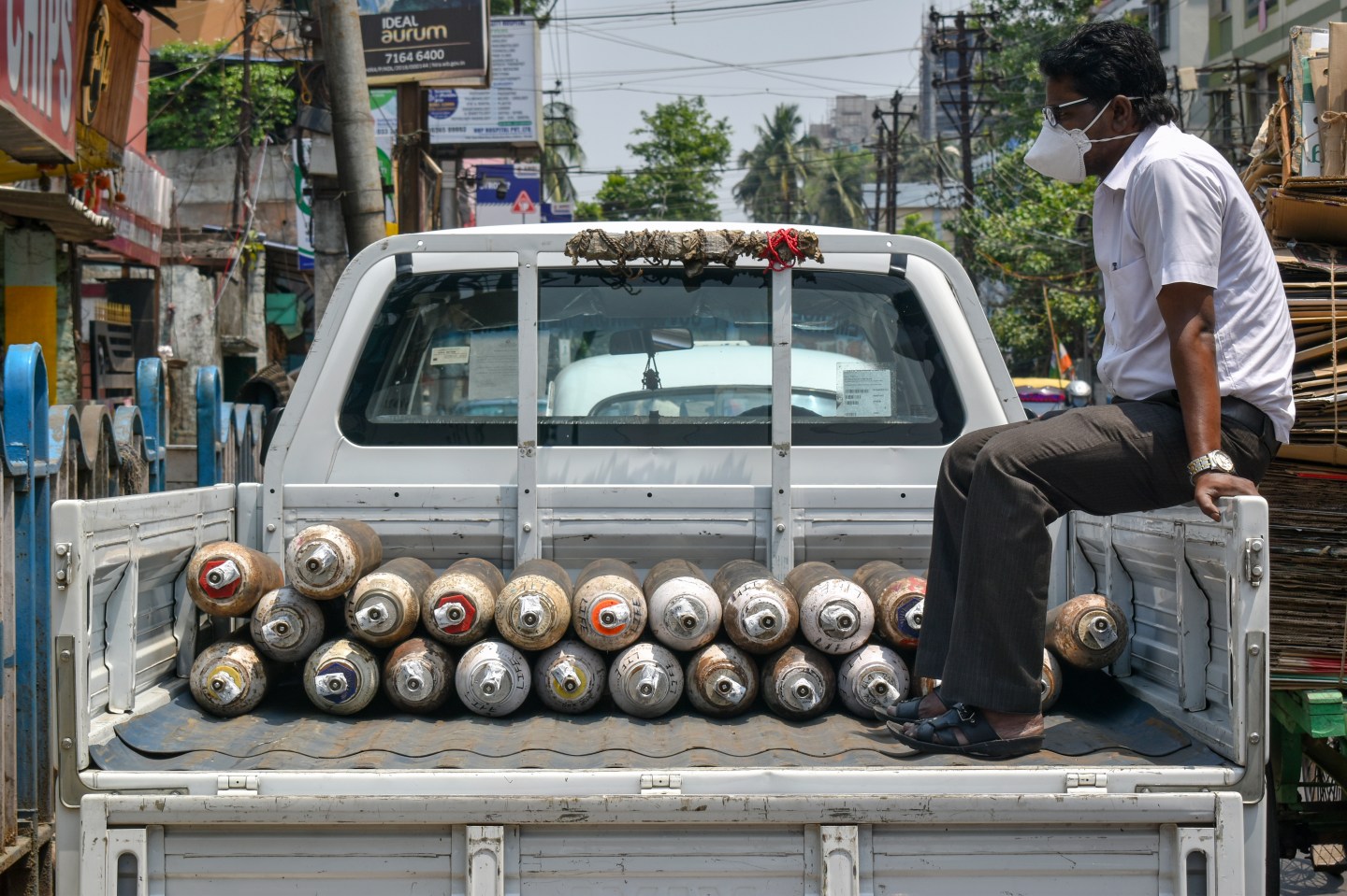 An employee of an oxygen refilling shop sitting on a mini