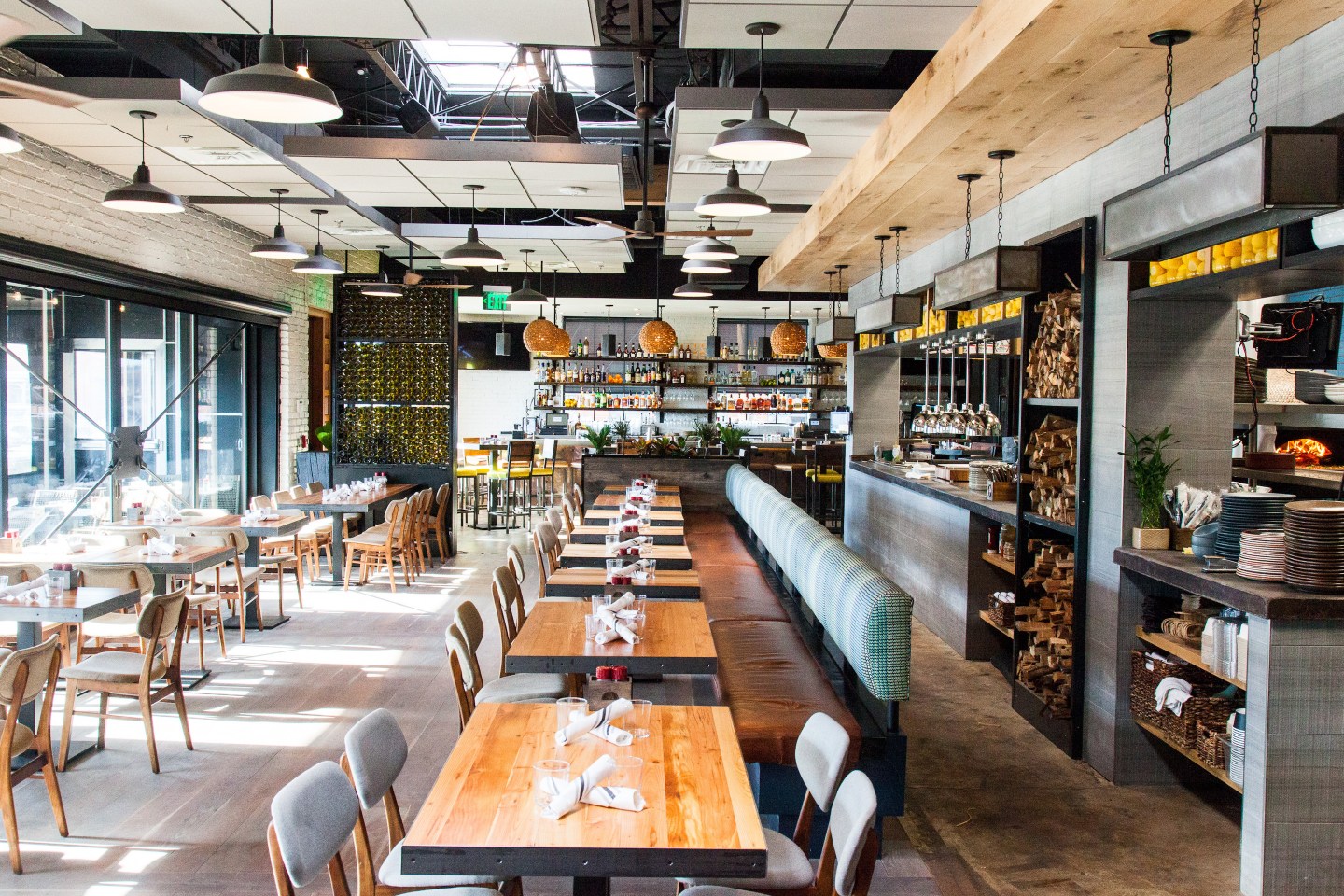 Tazza Kitchen restaurant location; interior of restaurant with empty tables and natural light