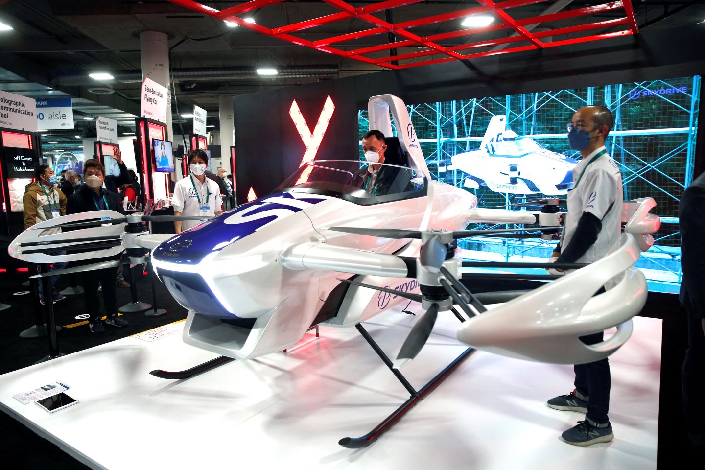 An attendee checks out a zero-emissions SkyDrive flying car.
