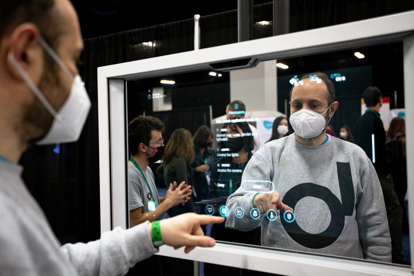 Baracoda Daily Healthtech employee Thomas Serval demonstrates the company's smart mirror