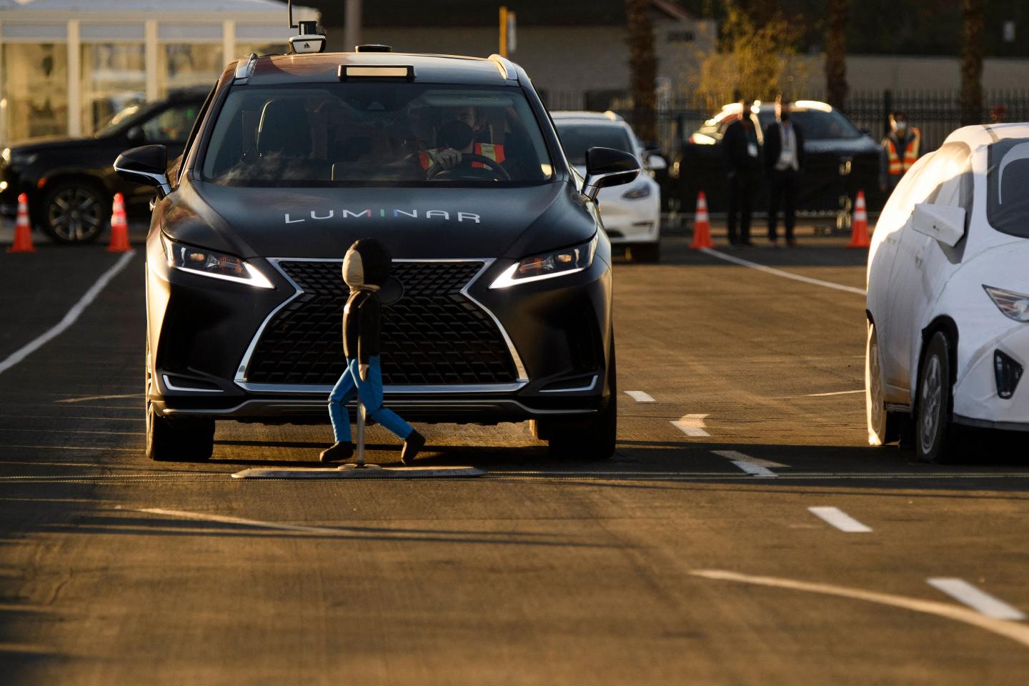 A vehicle with Luminar LiDAR based Proactive Safety pre-collision braking crash avoidance technology stops to avoid a child-sized test dummy as it is demonstrated on a test track.