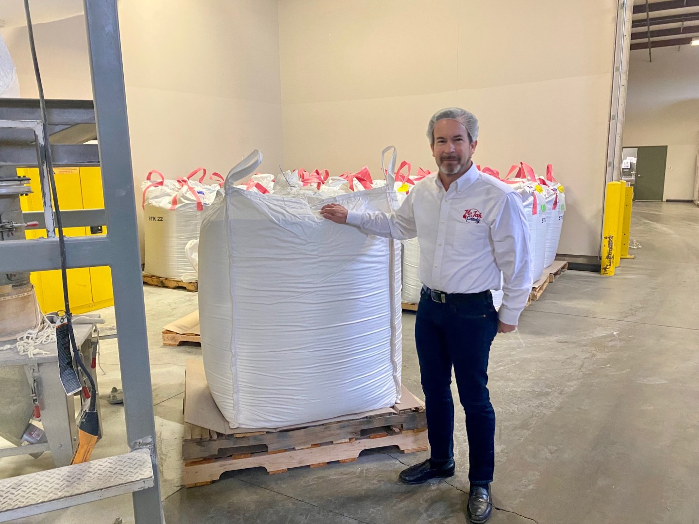 Photo of a McJak Candy president Larry Johns with sugar