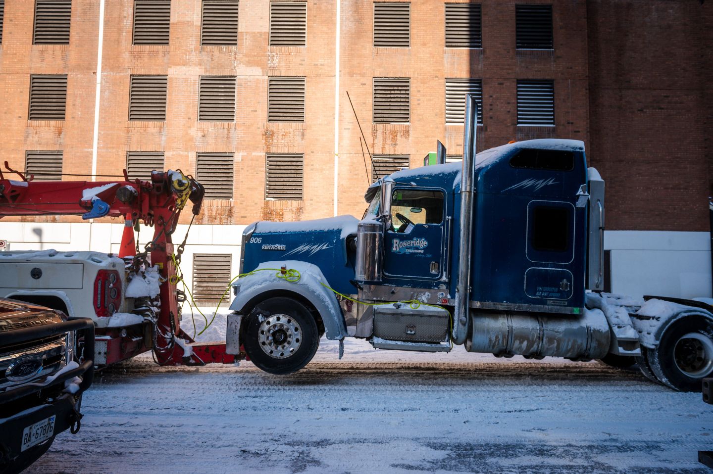 A truck taking part in the Freedom Convoy protests in Ottawa is towed away
