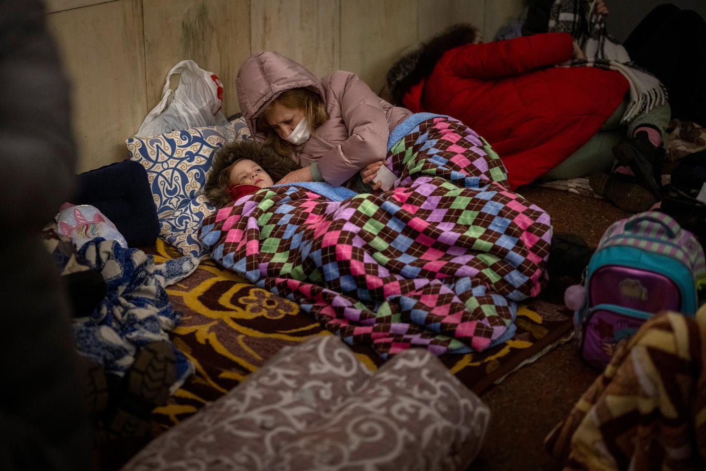 People rest in the Kyiv subway, using it as a bomb shelter in Kyiv, Ukraine, Thursday, Feb. 24, 2022.
