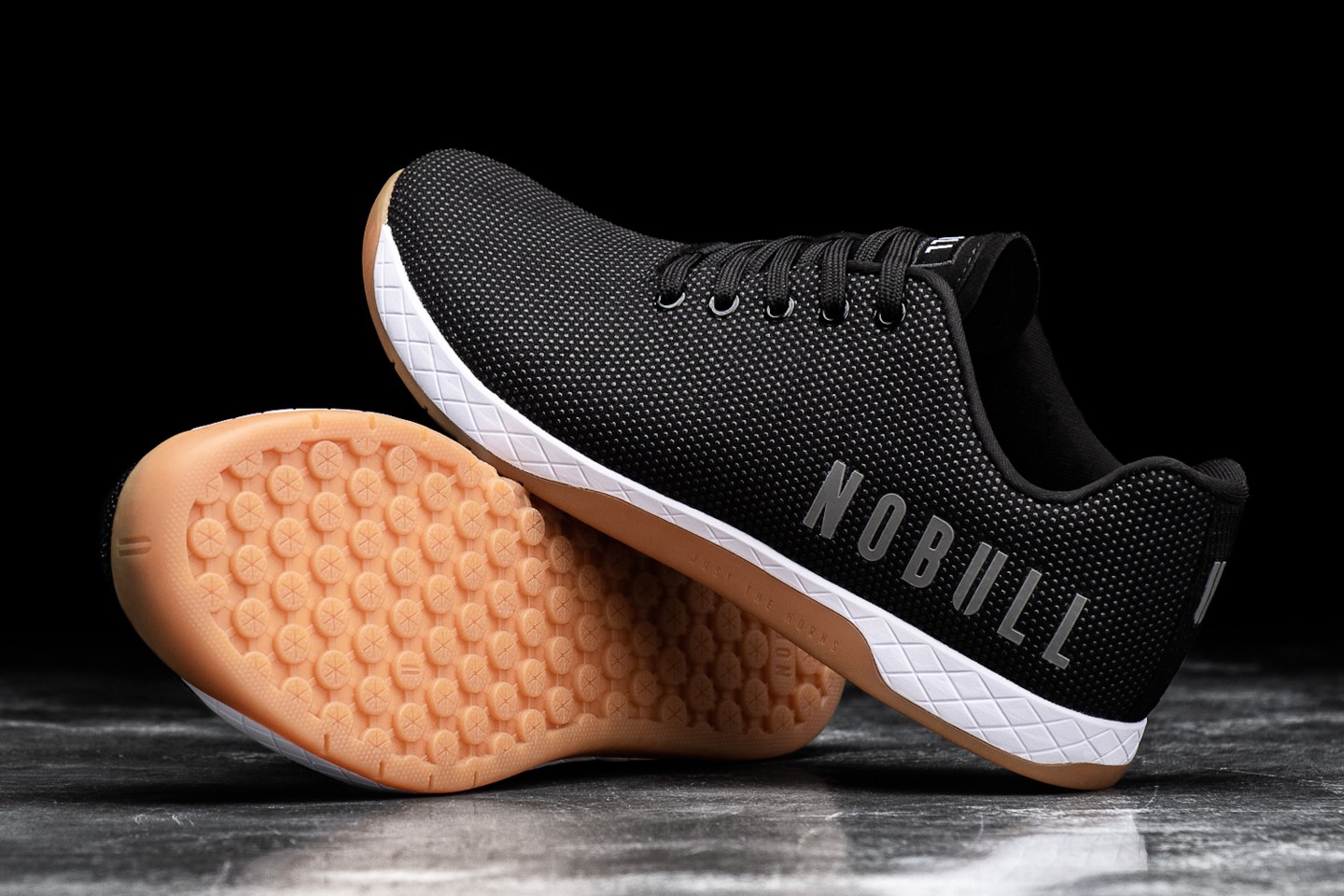 A pair of NOBULL's signature trainers in black and white.