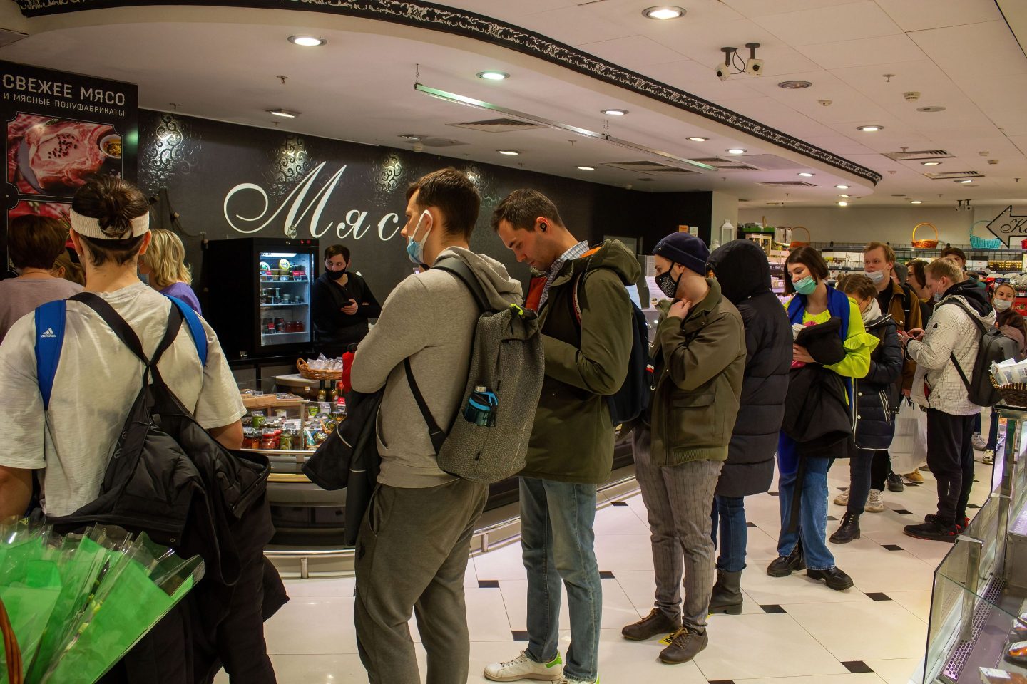 Photo of Russians lining up inside a supermarket to withdraw cash from an ATM on March 3, 2022 in Moscow, Russia.