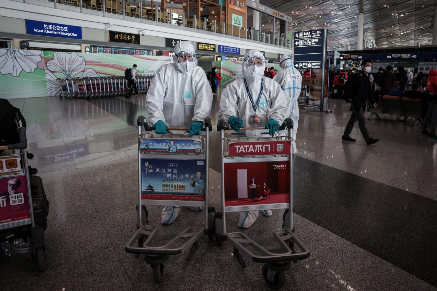 Airport staff in hazmat suits