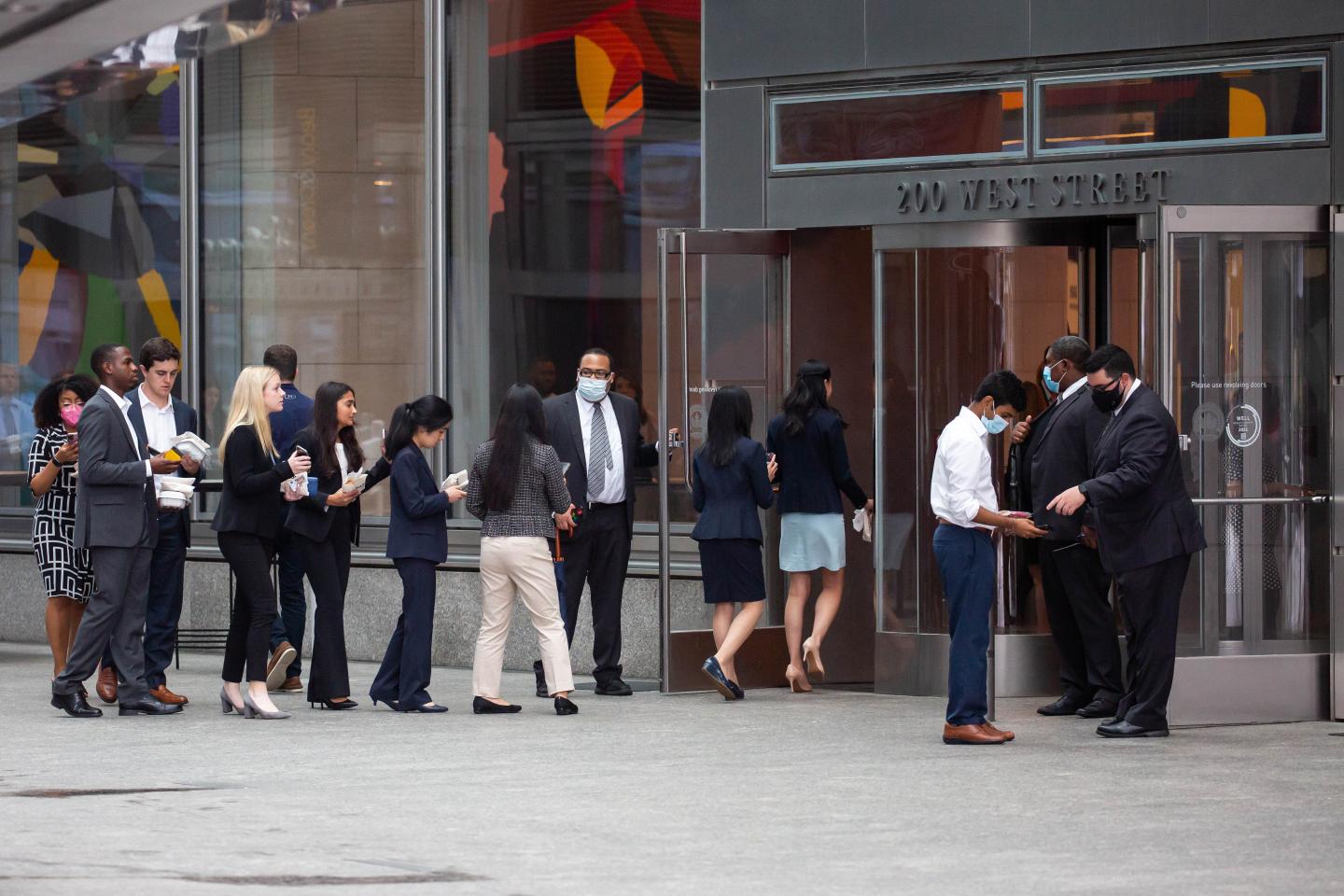 People wait in line to enter outside the Goldman Sachs headquarters building in New York,