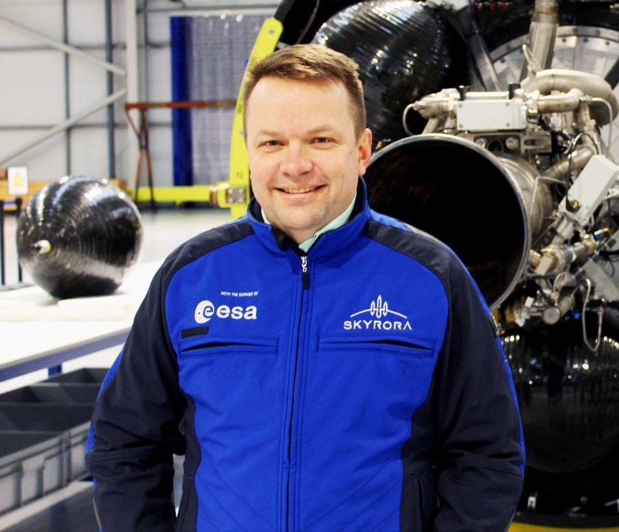 Photo of Skyrora CEO Volodymyr Levykin standing in front of a rocket engine.