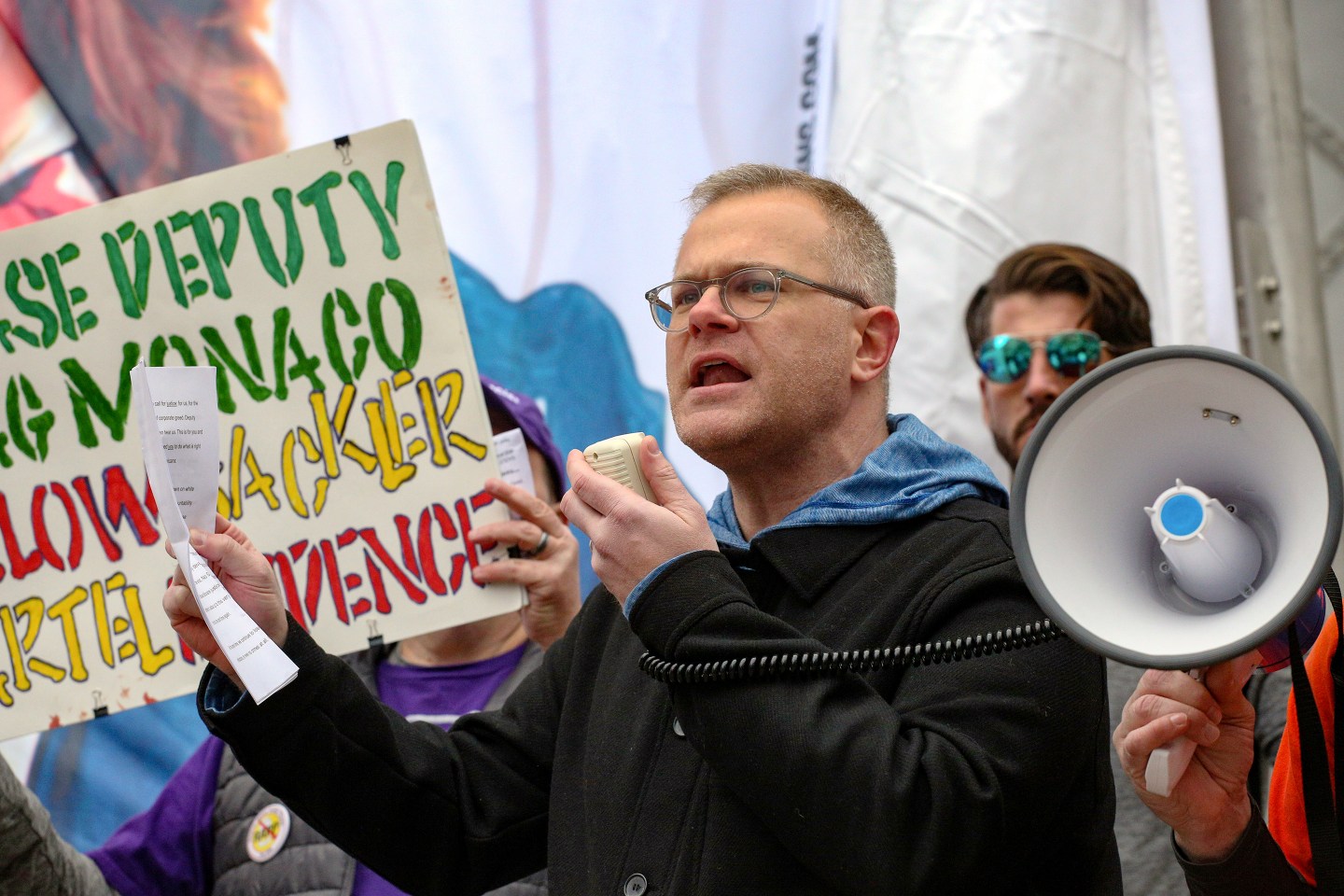 Ryan Hampton protests outside the DOJ.