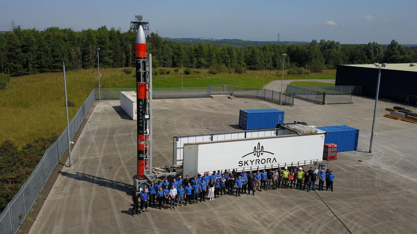 Photo of Skyrora employees posing next to the company's Skylark L rocket.
