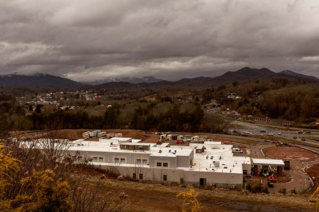 building under construction with mountains in the background