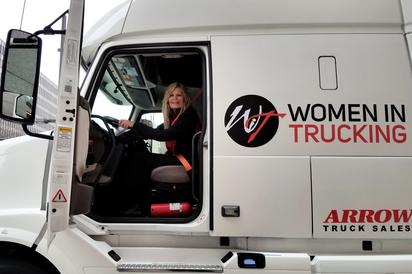 Ellen Voie, founder of Women in Trucking, sits in a truck.