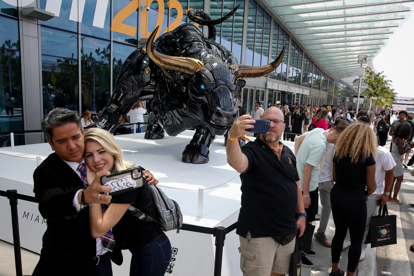 Attendees take selfies with The Miami Bull during the Bitcoin 2022 Conference at Miami Beach Convention Center on April 7, 2022 in Miami, Florida.