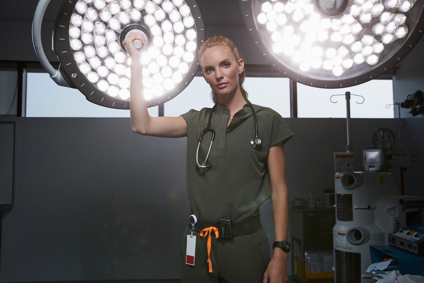 woman in doctor scrubs in an operating room