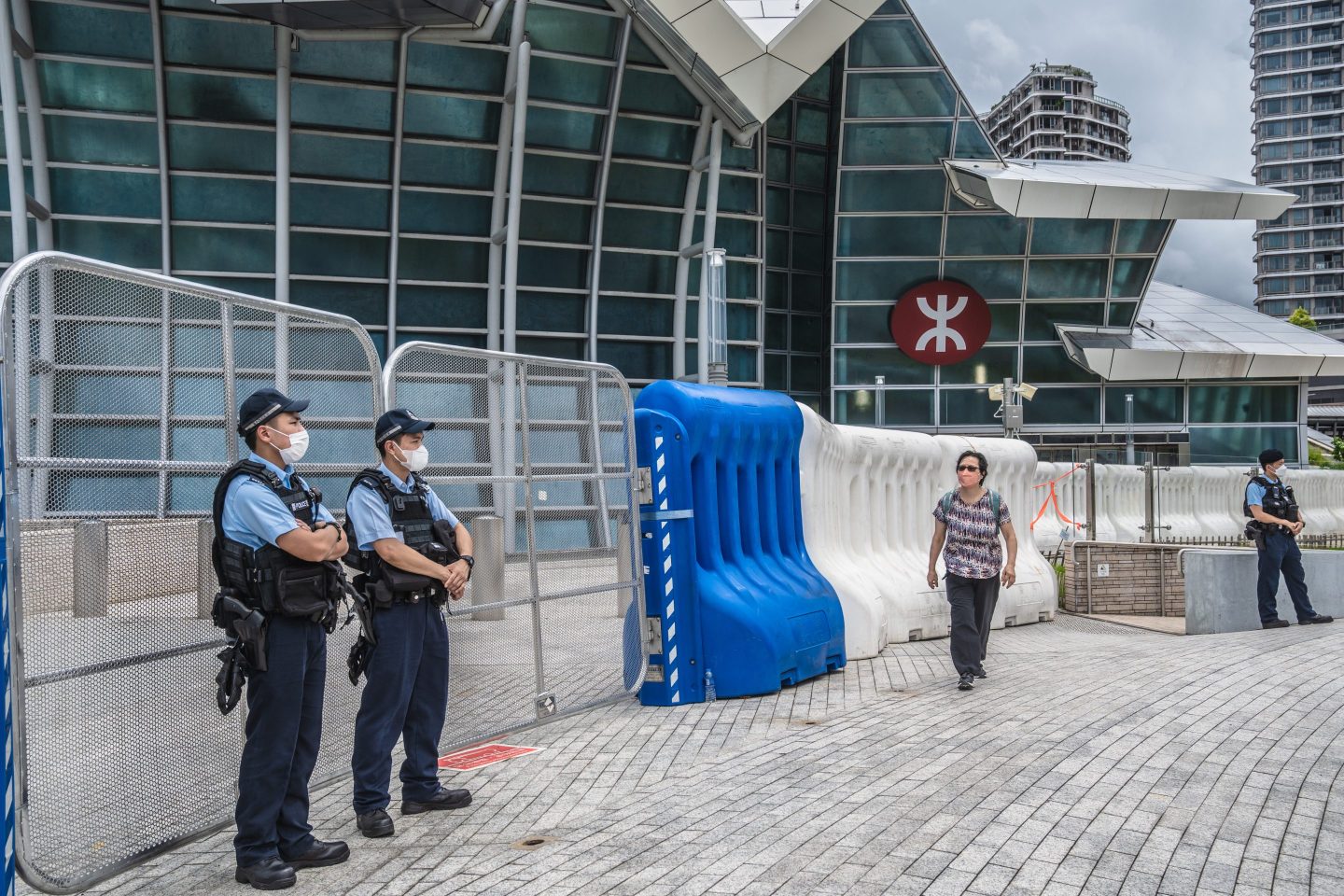 Guards stand outside a metro station in Hong Kong, where Xi will arrive